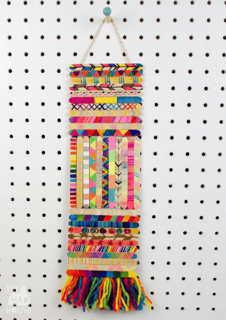 craft sticks made into a colorful wall hanging on peg board