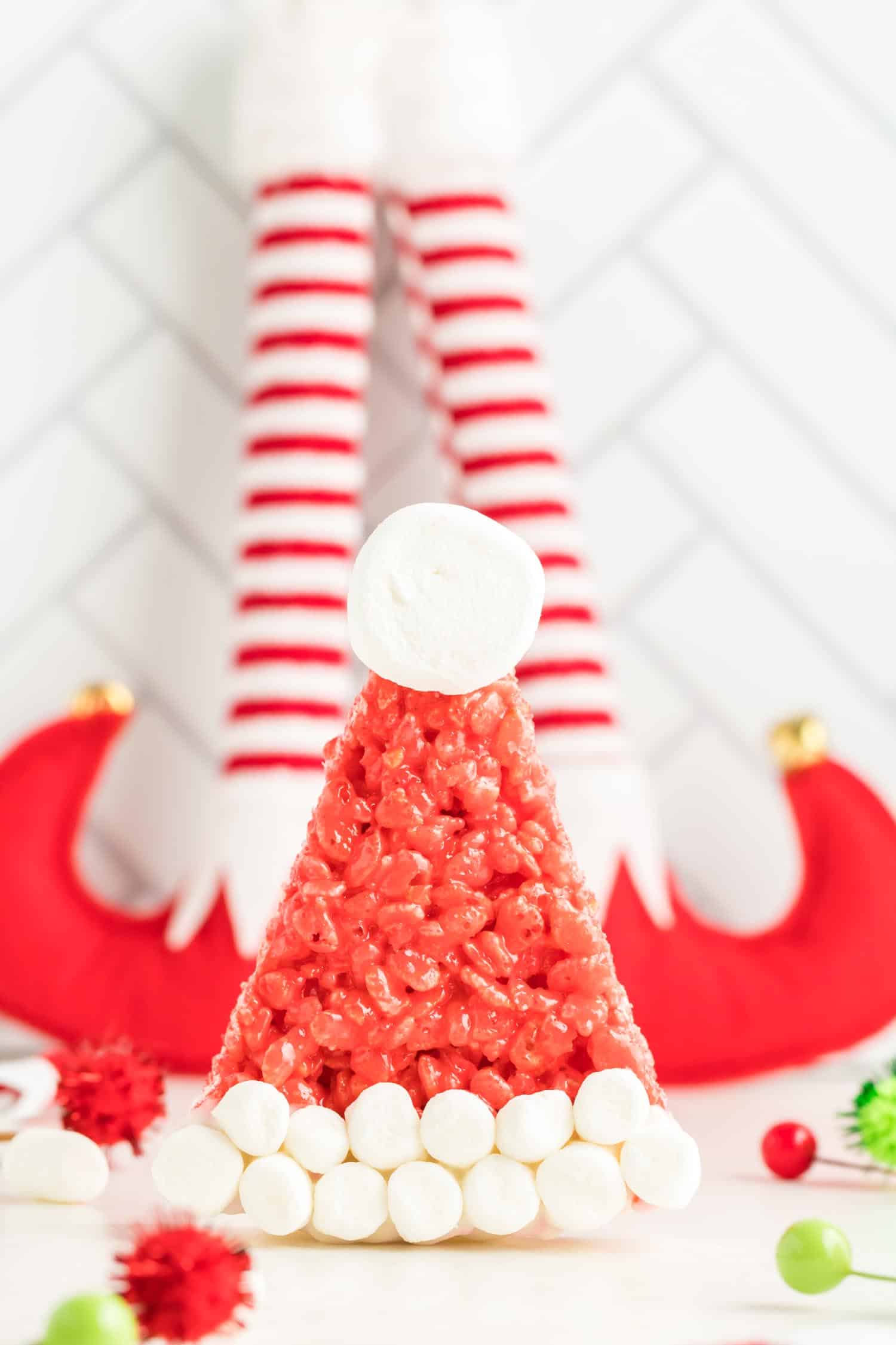 Rice Krispie Santa hat standing up in front of elf feet