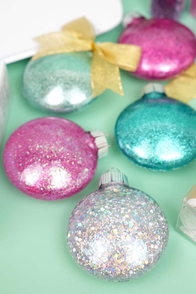 glitter ornaments are sitting on a green surface