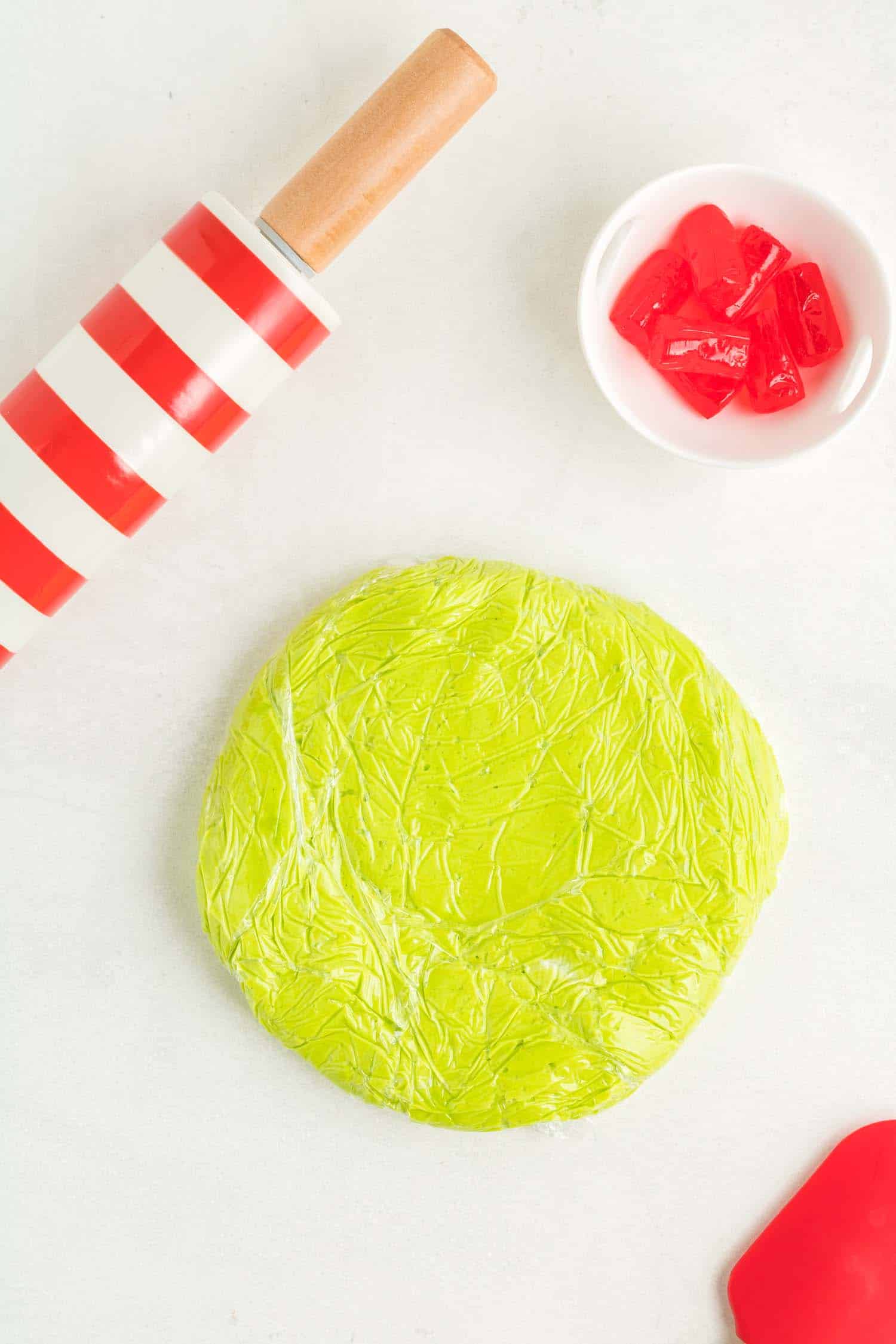 Flattened Dough for Grinch Green Sugar Cookies with rolling pin