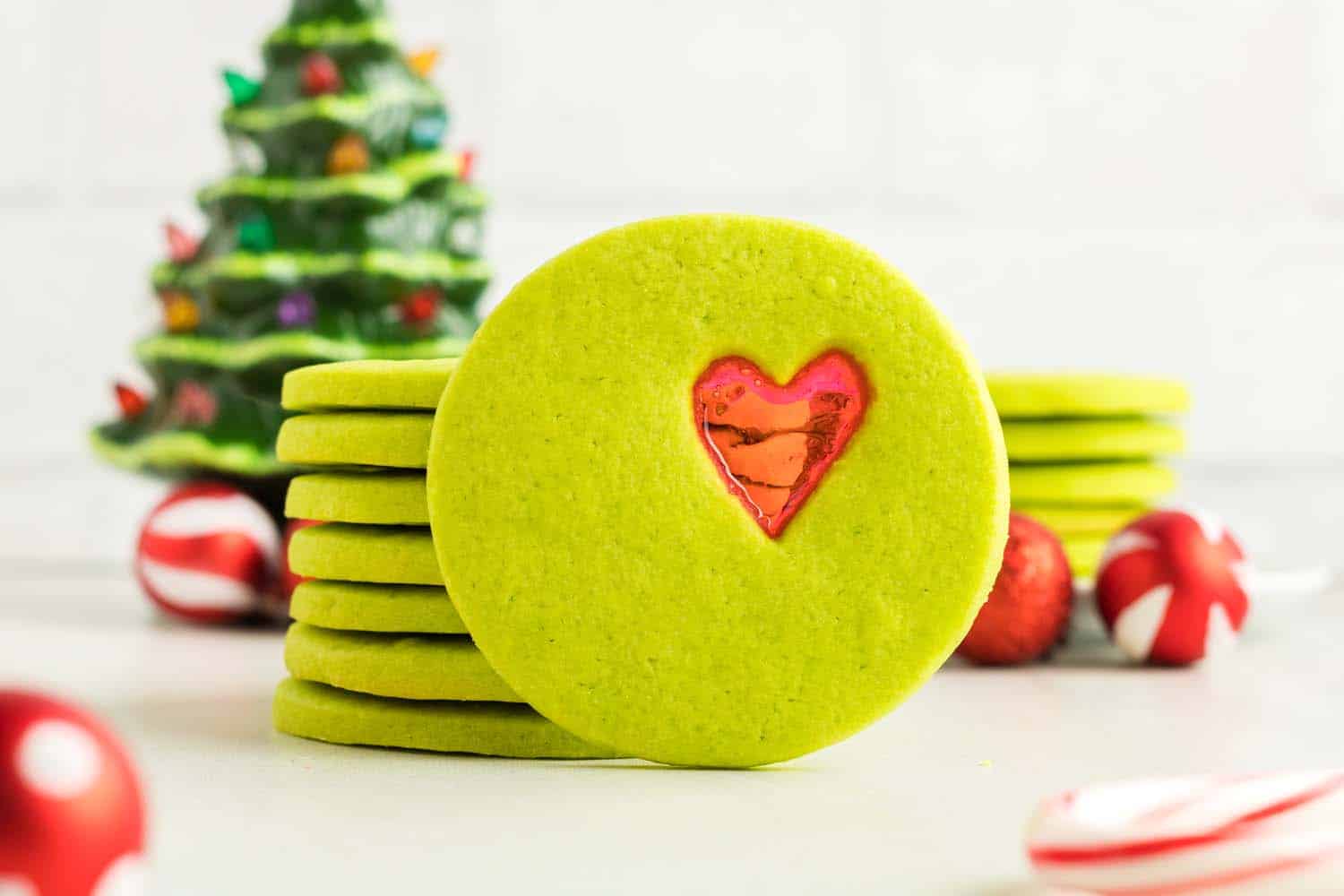 Green sugar cookie stacked with Christmas background
