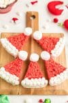 Five Rice Krispie Treats on cutting board background