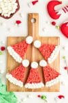 Santa hat Christmas desserts on wooden board