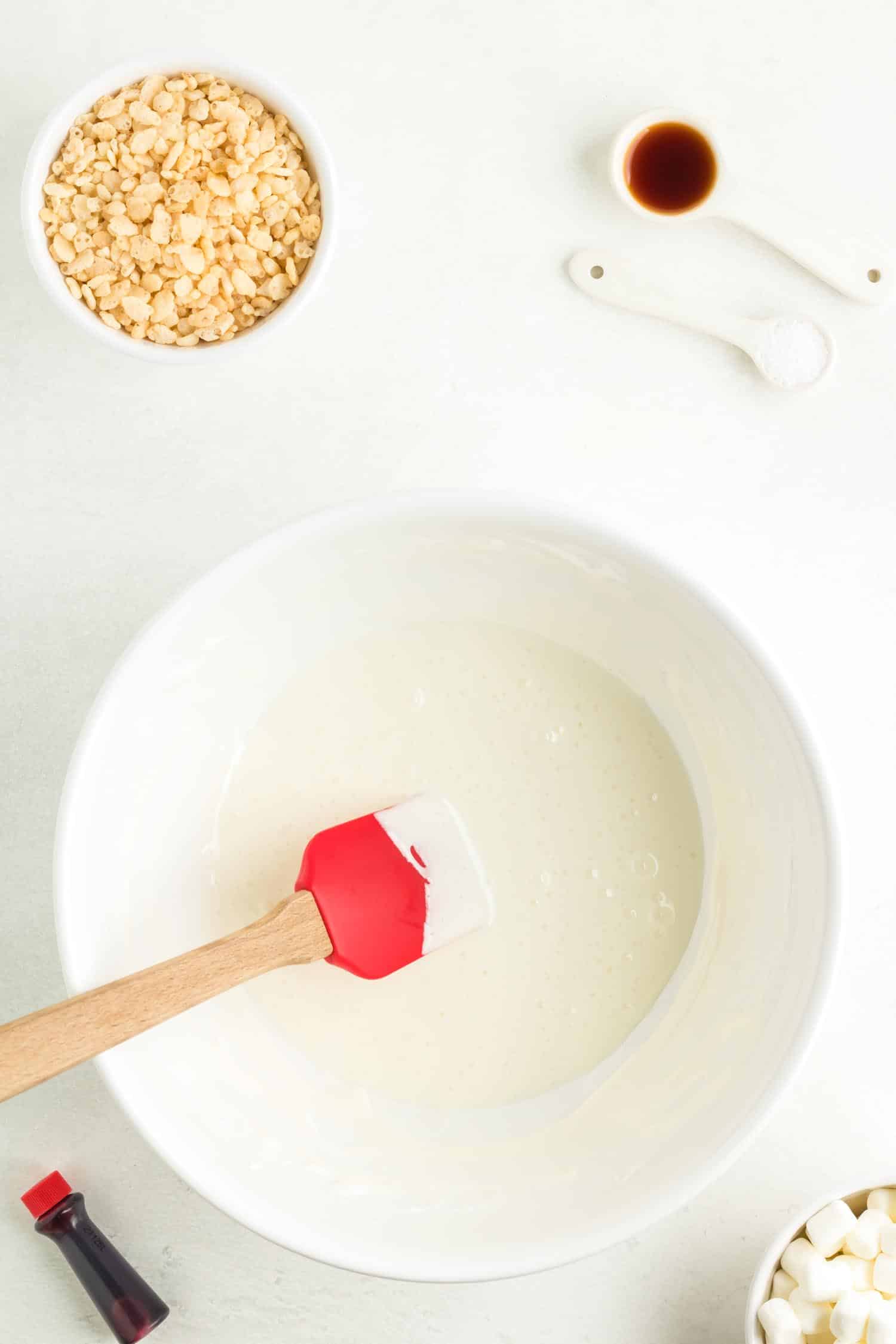 Mixing Santa hat Rice Krispie Treats ingredients