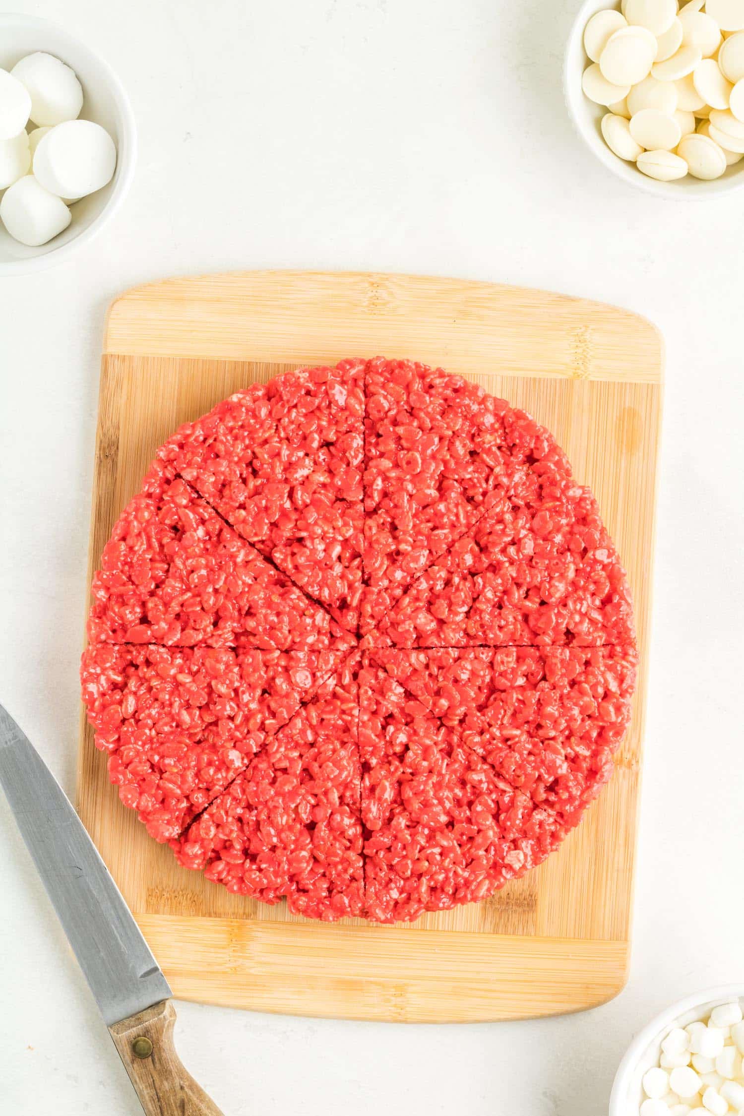 Red Rice Krispie sliced up on wooden cutting board