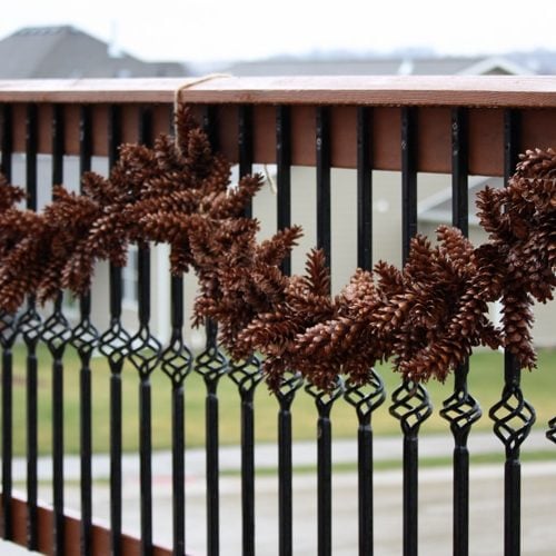 Pine cone garland hung on fence