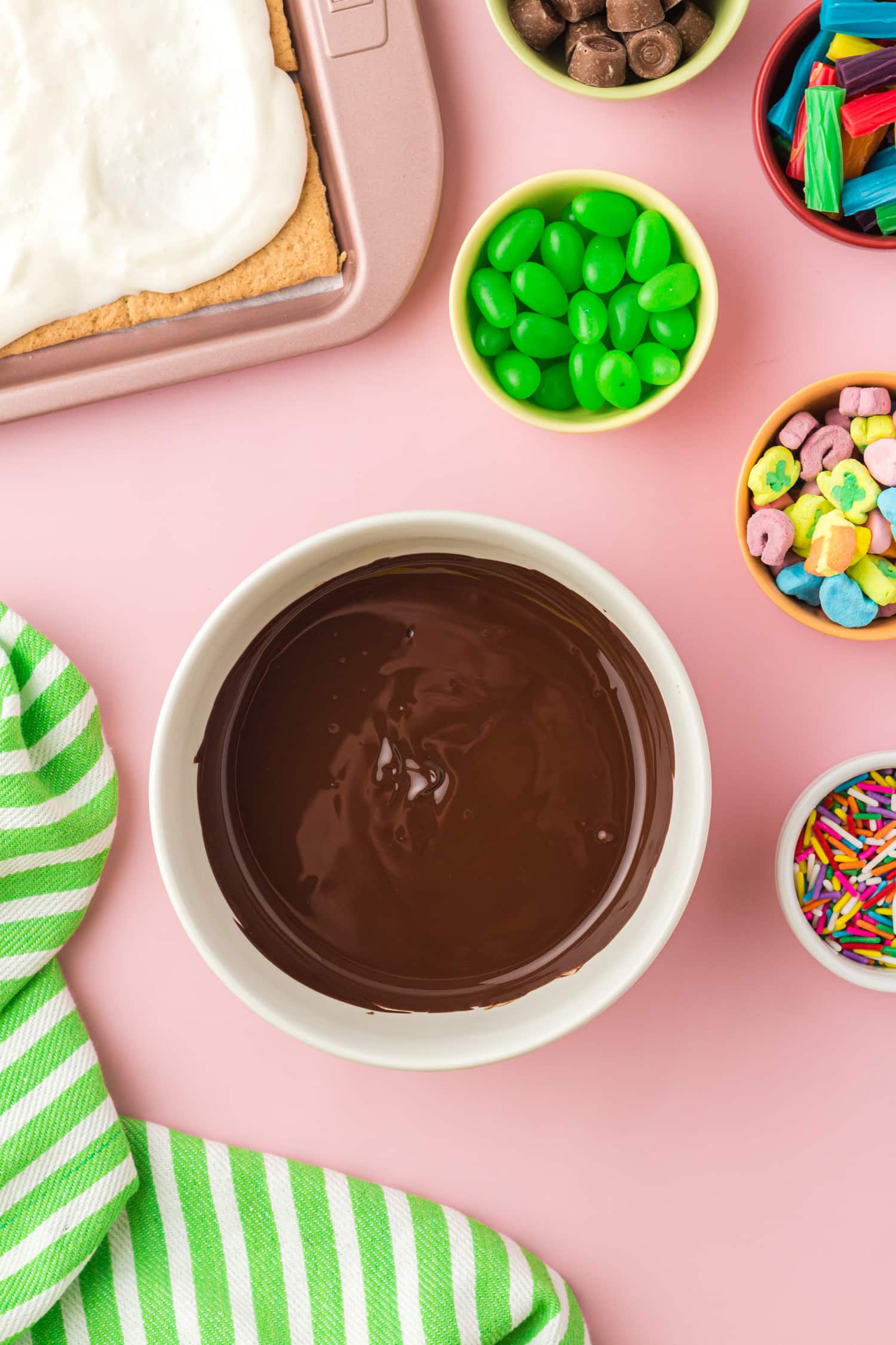 Melted chocolate in bowl with candy ingredients
