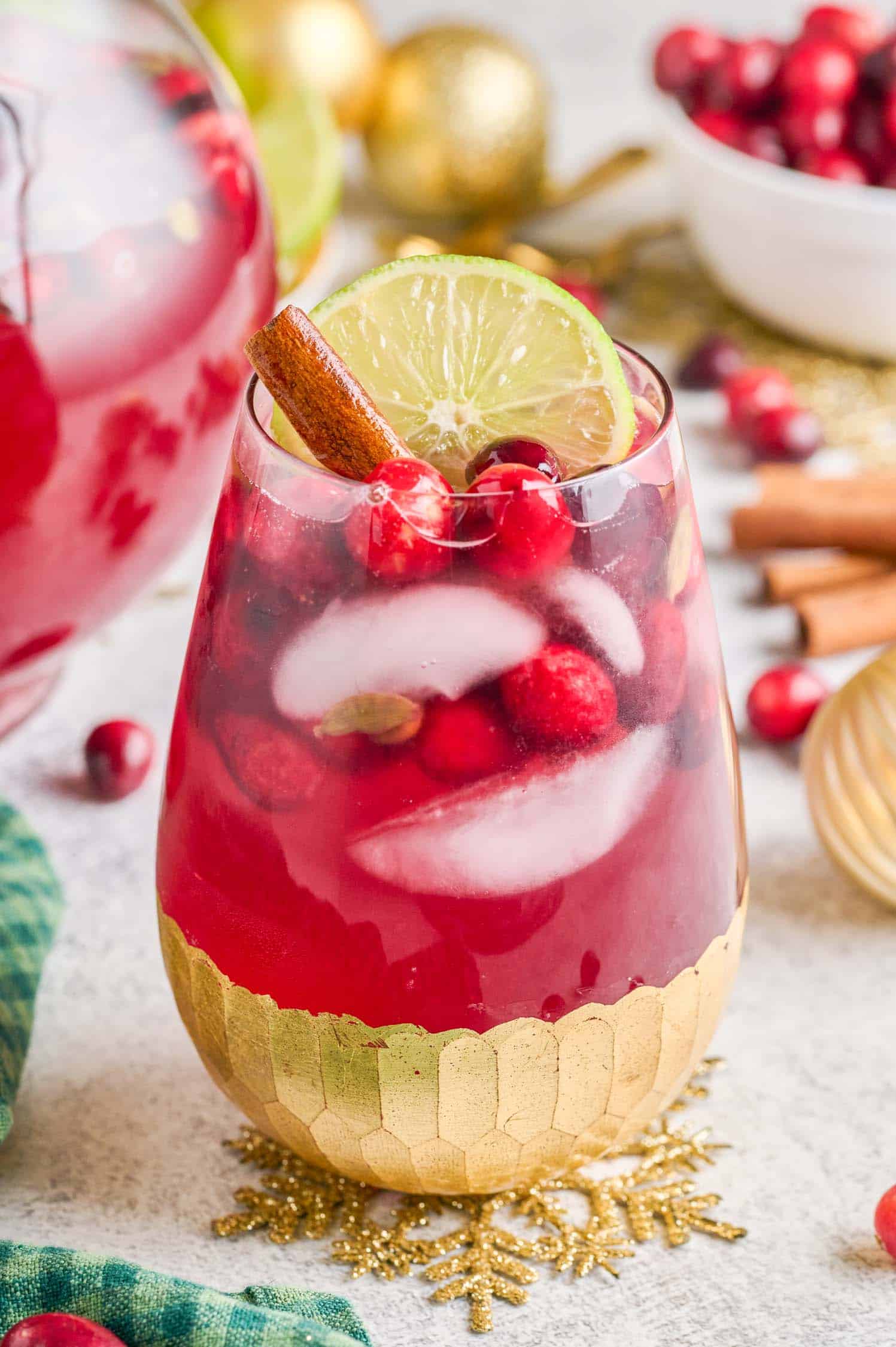 Spiced Cranberry Wine Spritzer in a gold leaf bottom covered wine glass