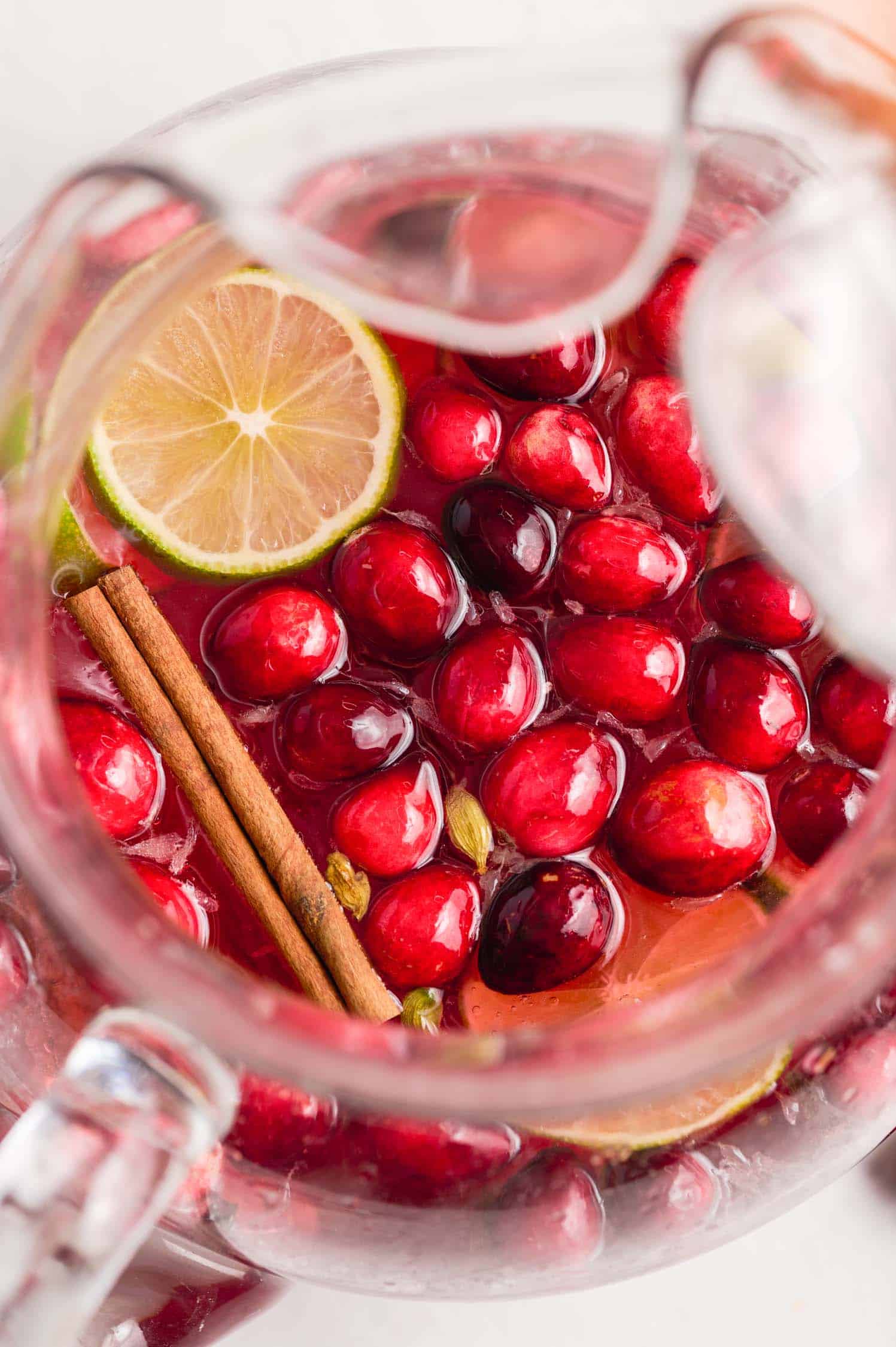 Closeup shot of cranberries floating in a glass pitcher