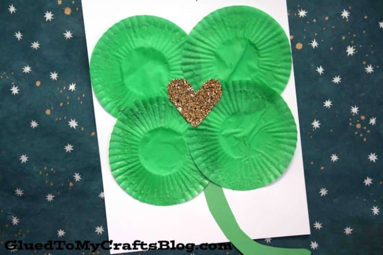 shamrock made from cupcake liners glued to paper with gold heart in the middle