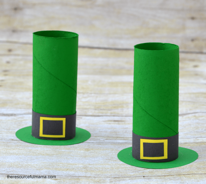 two toilet paper roll tube leprechaun hats on wooden table