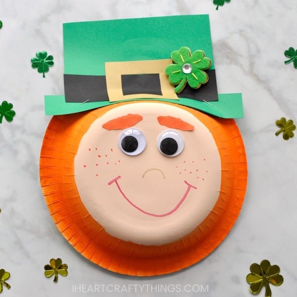 leprechaun face made from paper plate and paper with tiny shamrock confetti