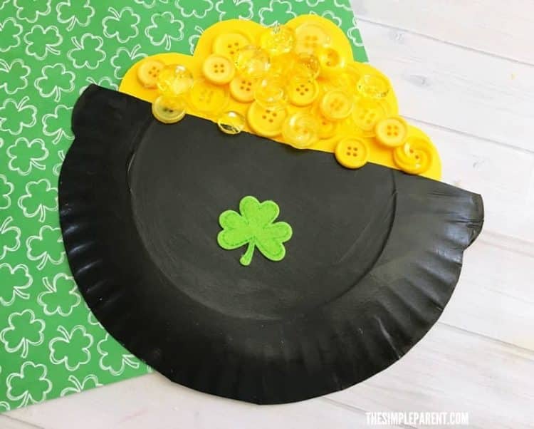pot of gold made from paper plate, colored black with yellow buttons glued to the top