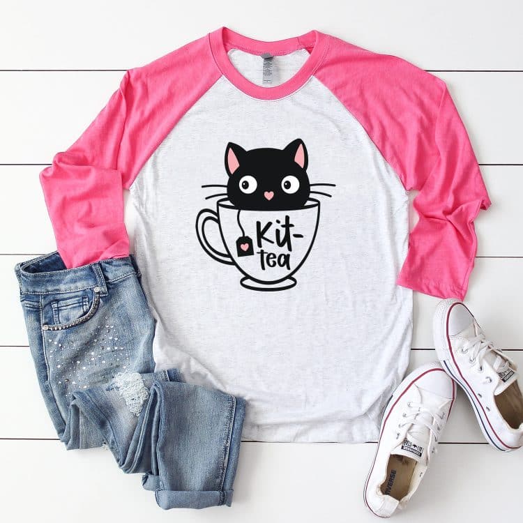 Pink sleeved raglan shirt with "Kit-Tea" kitten in a teacup design
