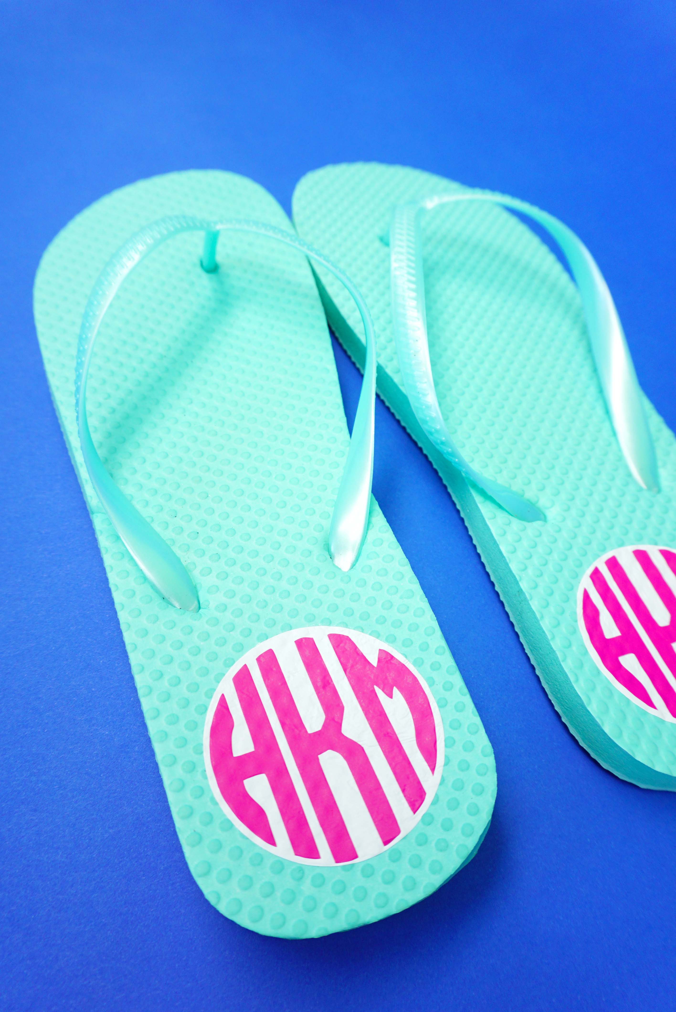teal sandals with iron on print on a blue background