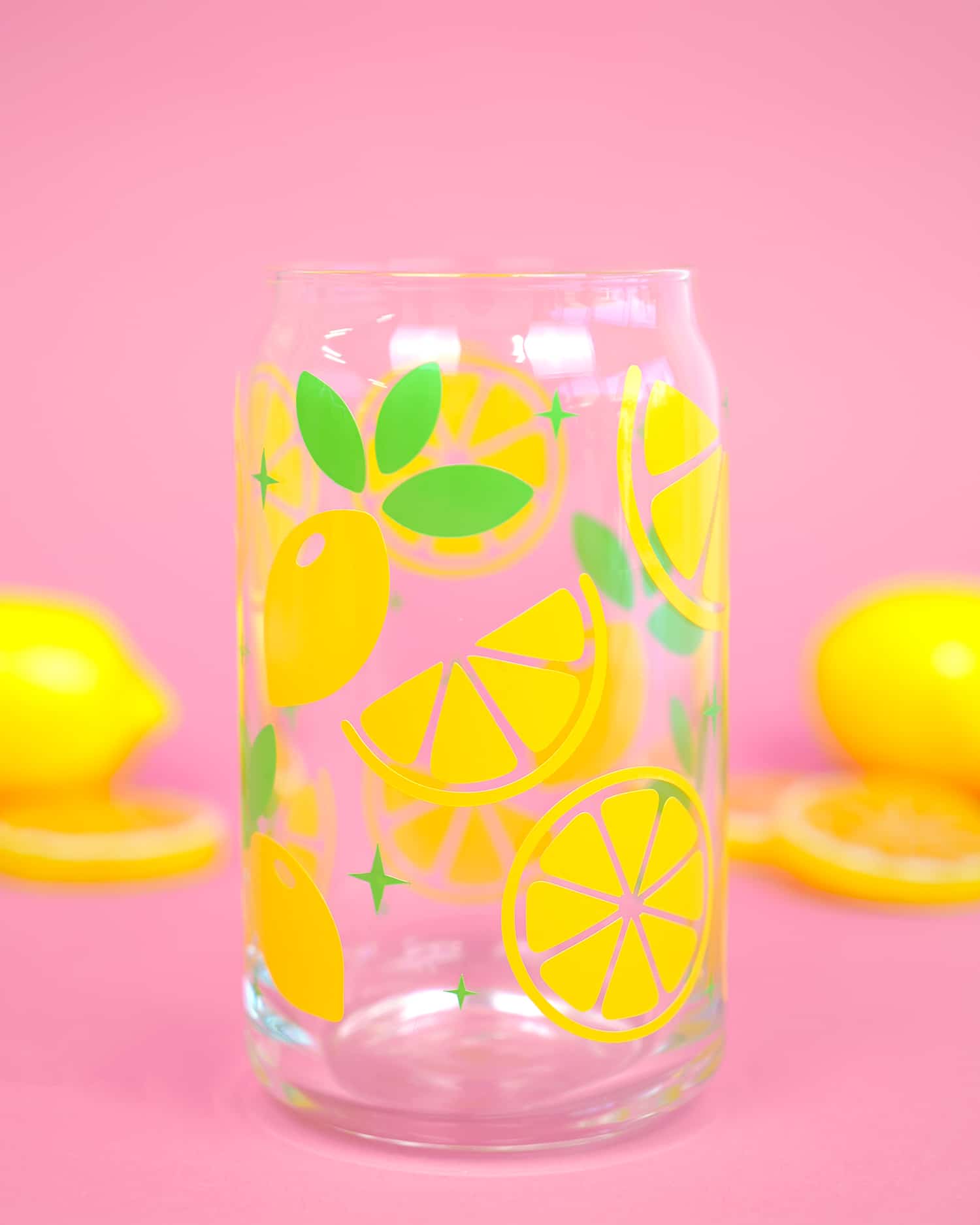 lemon slices on glass with pink bakground with lemon slices in background