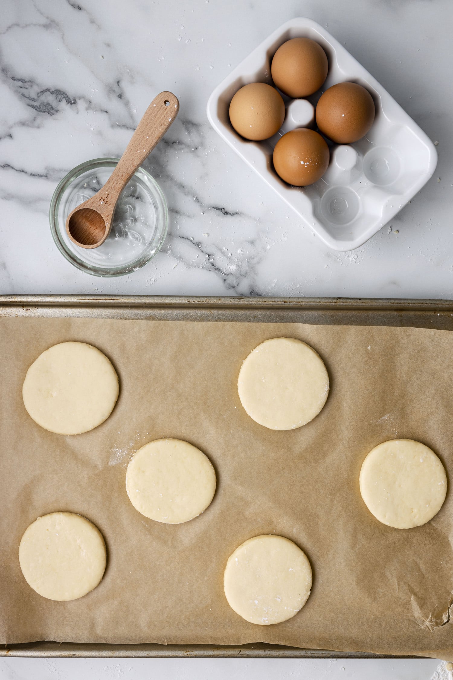 Round cookies placed on parchment paper