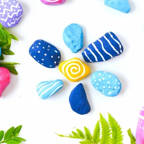 colorful painted rocks on white background