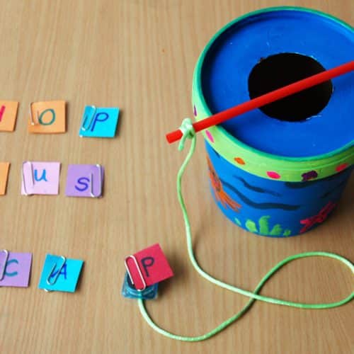 Fishing for letters craft setup with letters laid on table next to fishing bucket