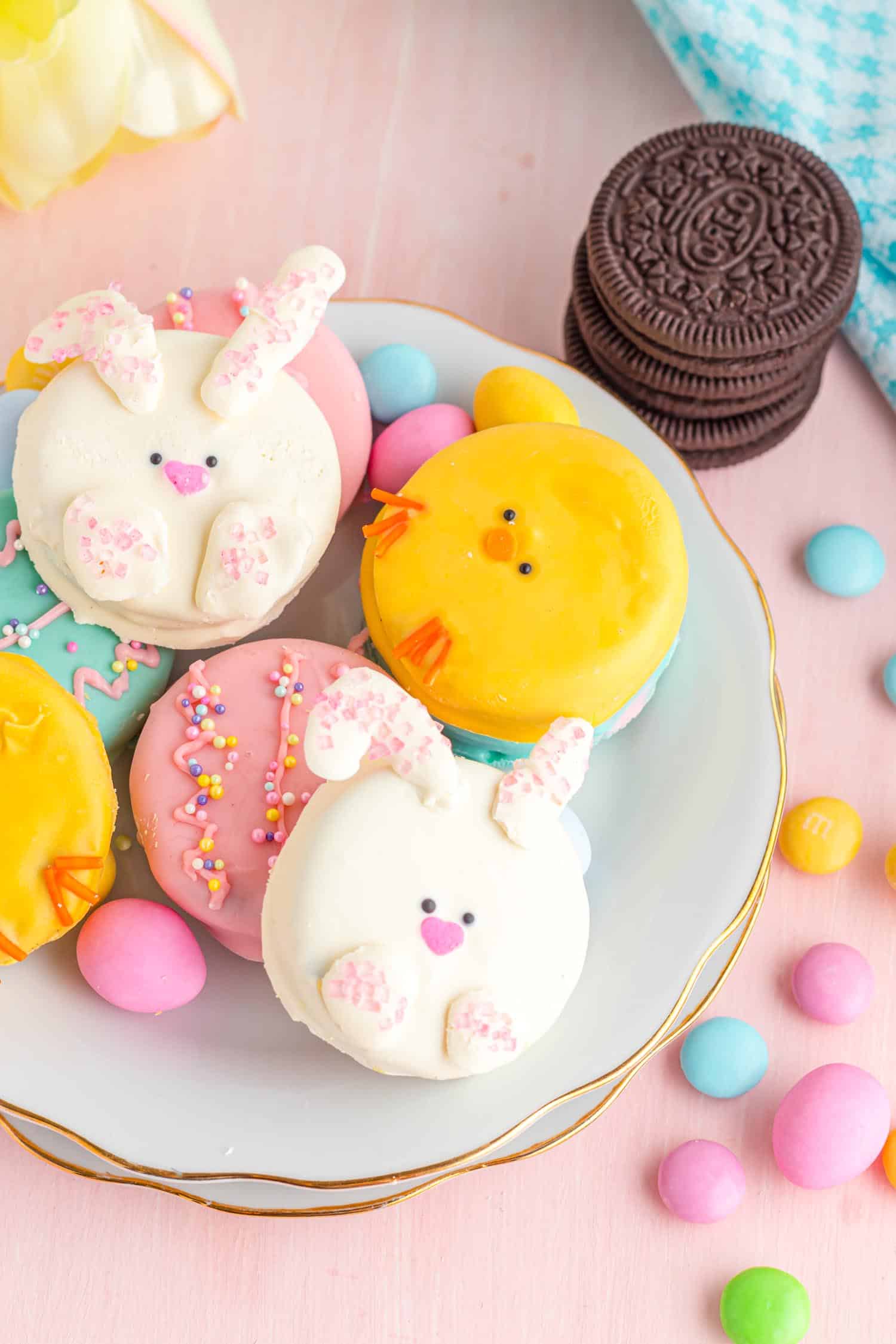 Easter Themed Chocolate Covered Oreos on a platter on a candy covered table