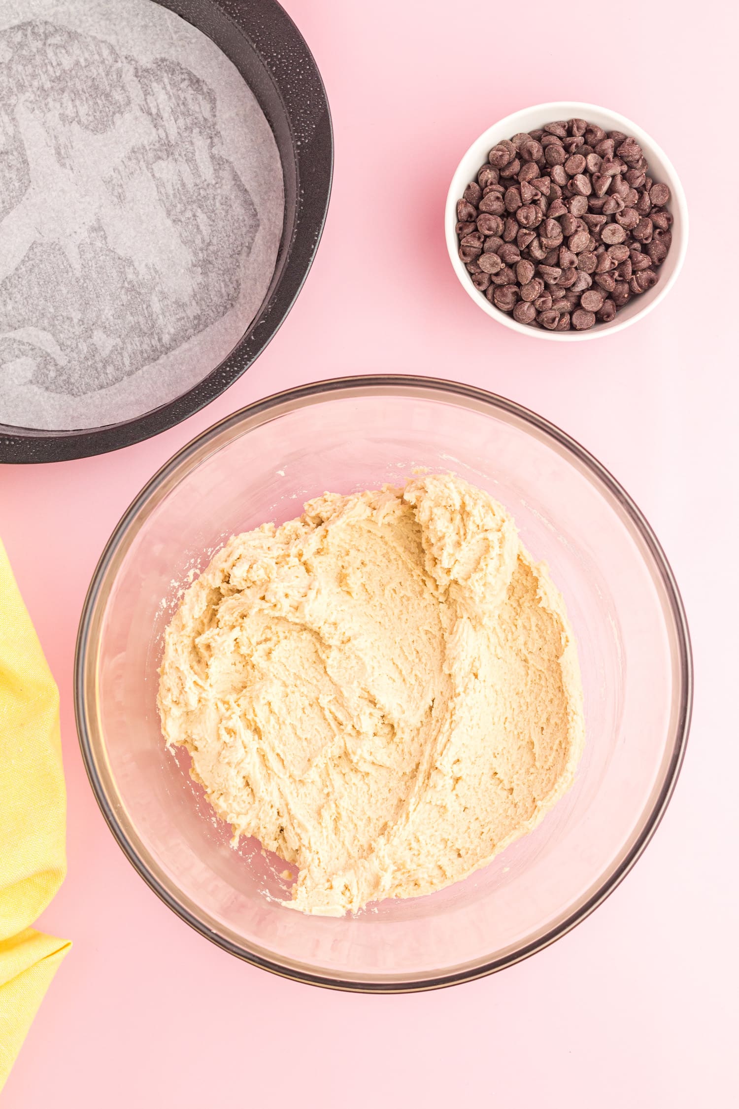 Chocolate chip cookie pizza being mixed in bowl