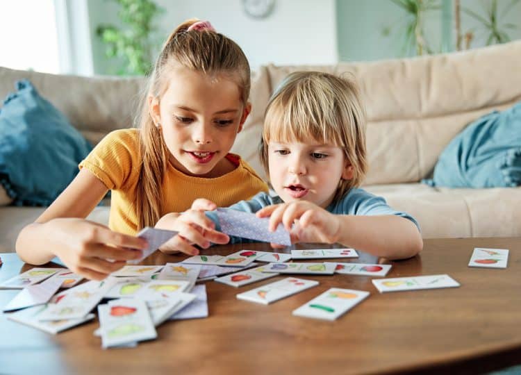 kids playing with a deck of cards in living room