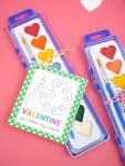 Heart-shaped watercolor paint set with a "Valentine, You Color My World" printable paint valentine card for kids