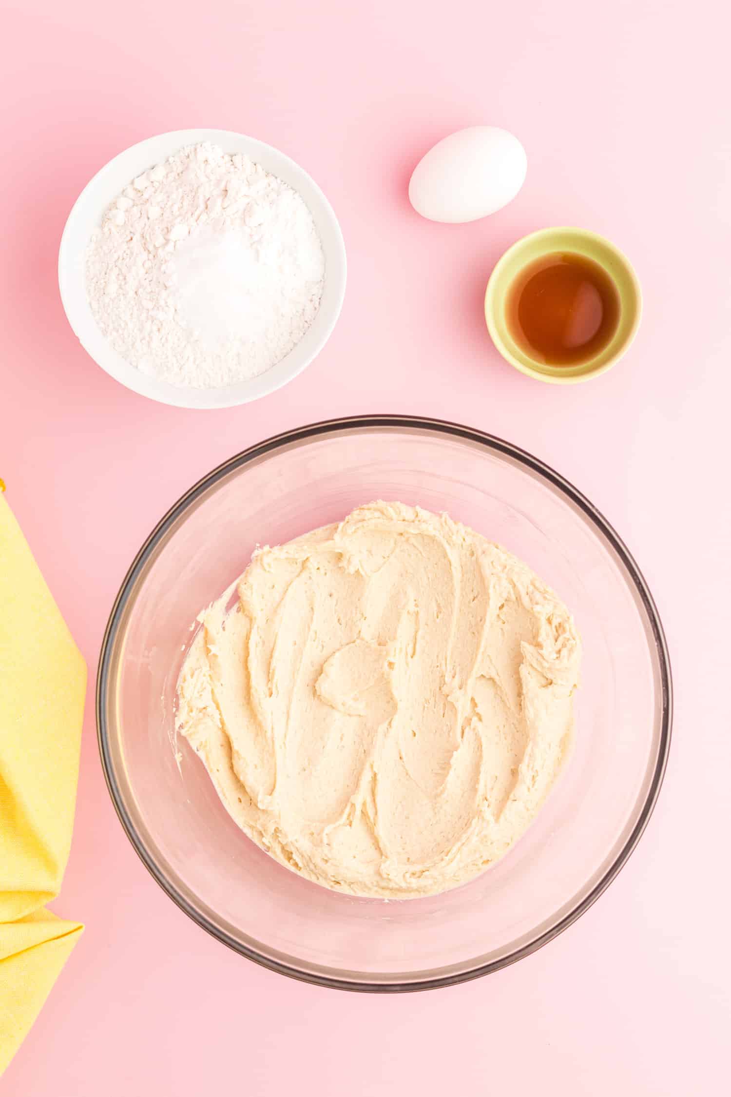 Cake ingredients being combined in a clear mixing bowl