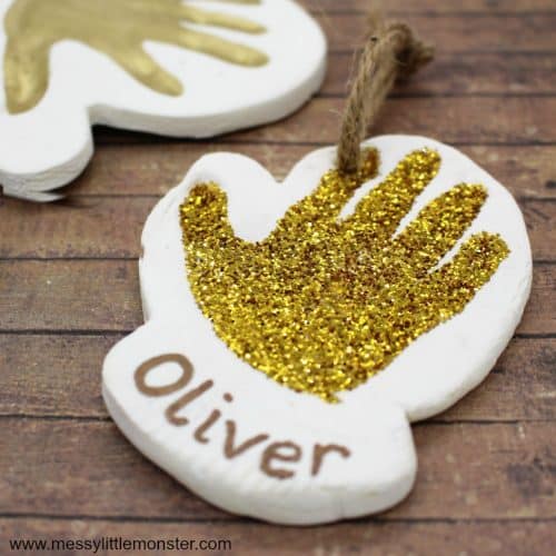 Baby handprints pressed into clay as a shiny ornament