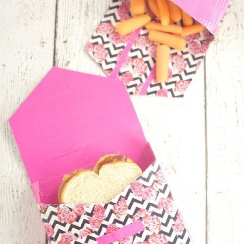 Lunch bags made from duct tape, pictured with flap of bag open and food inside