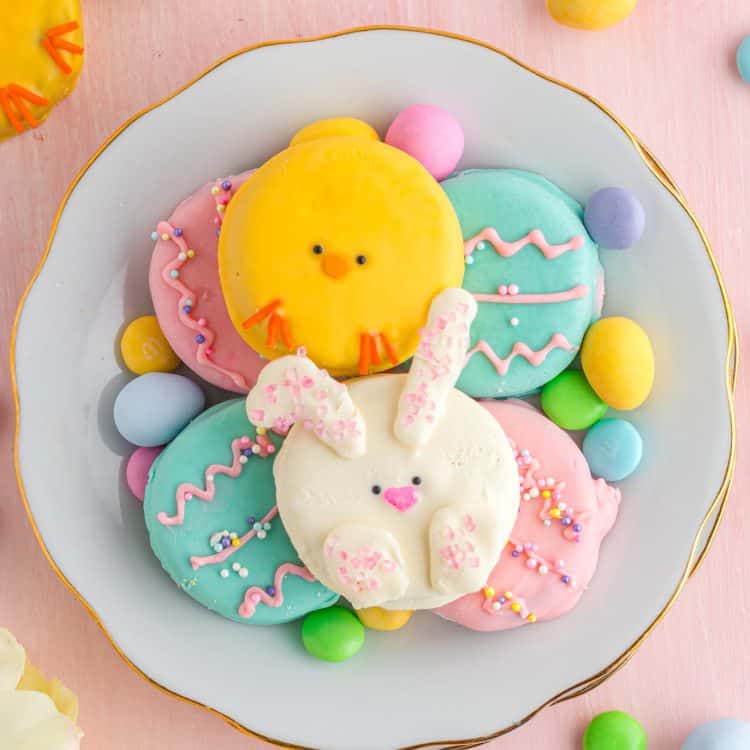easter oreos decorated like chicks, bunnies, easter eggs, on plate with easter decor