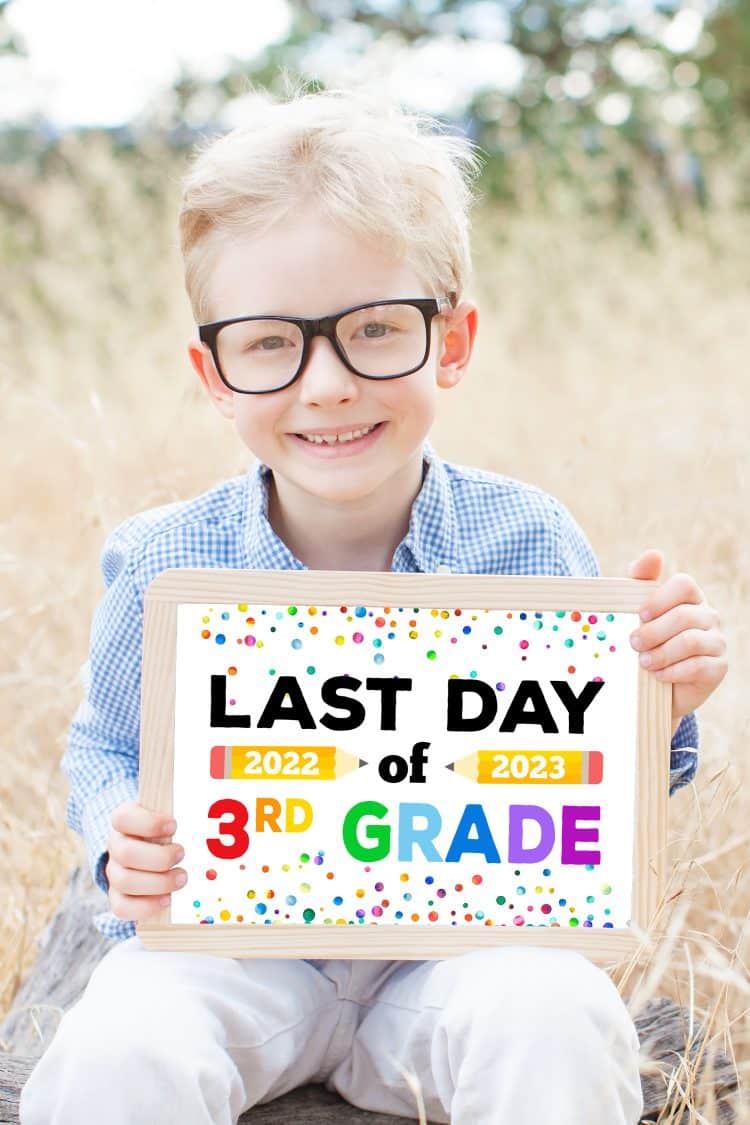 boy holding last day of 3rd grade sign