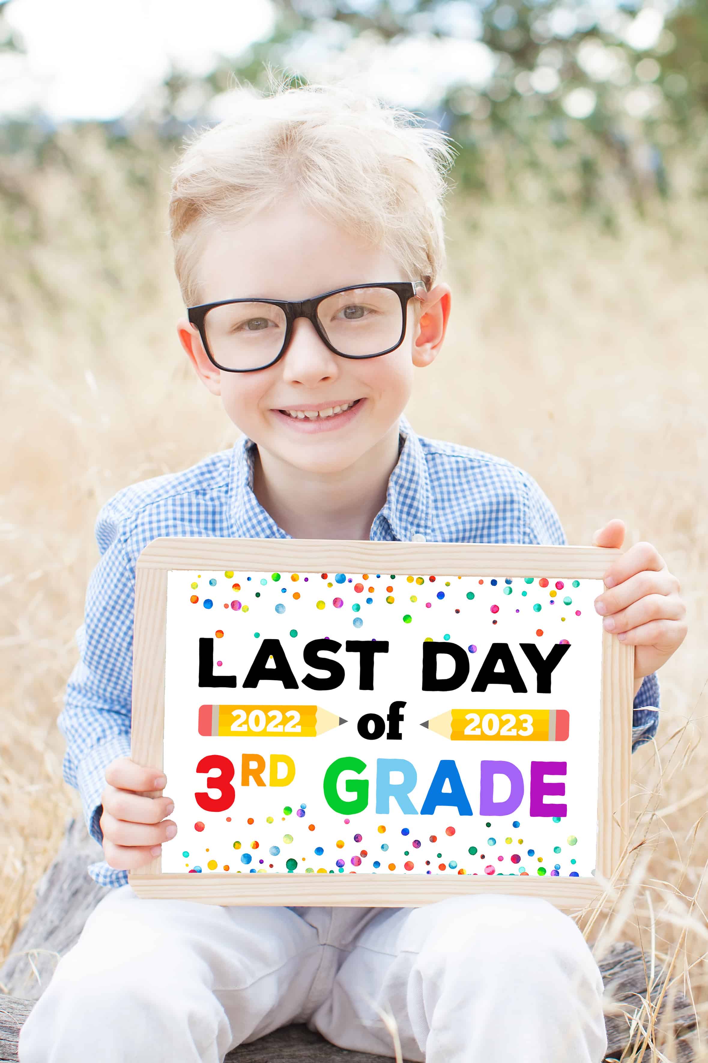 boy holding last day of 3rd grade sign