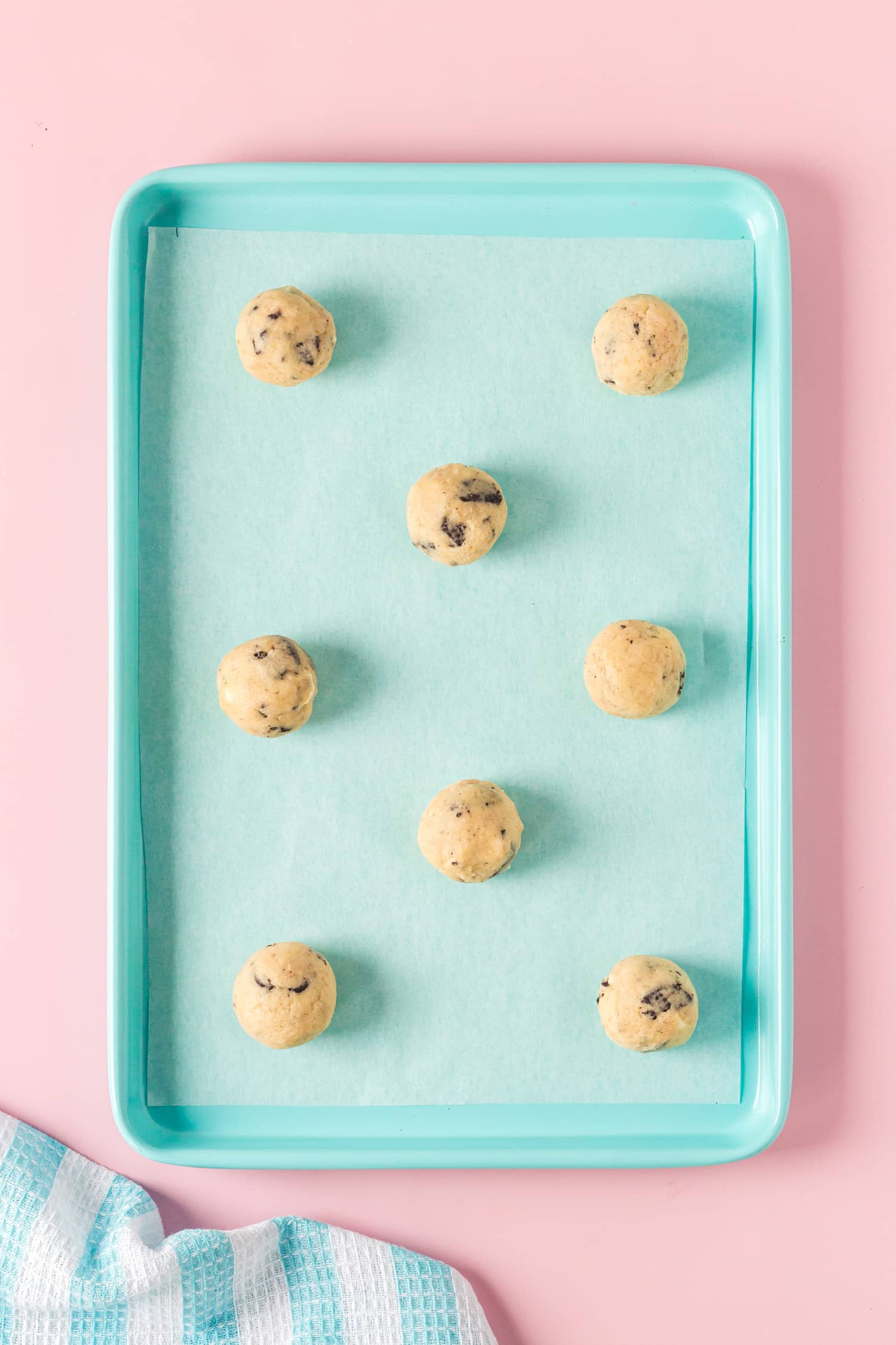 Scoop dough balls on blue platter for cookie recipe