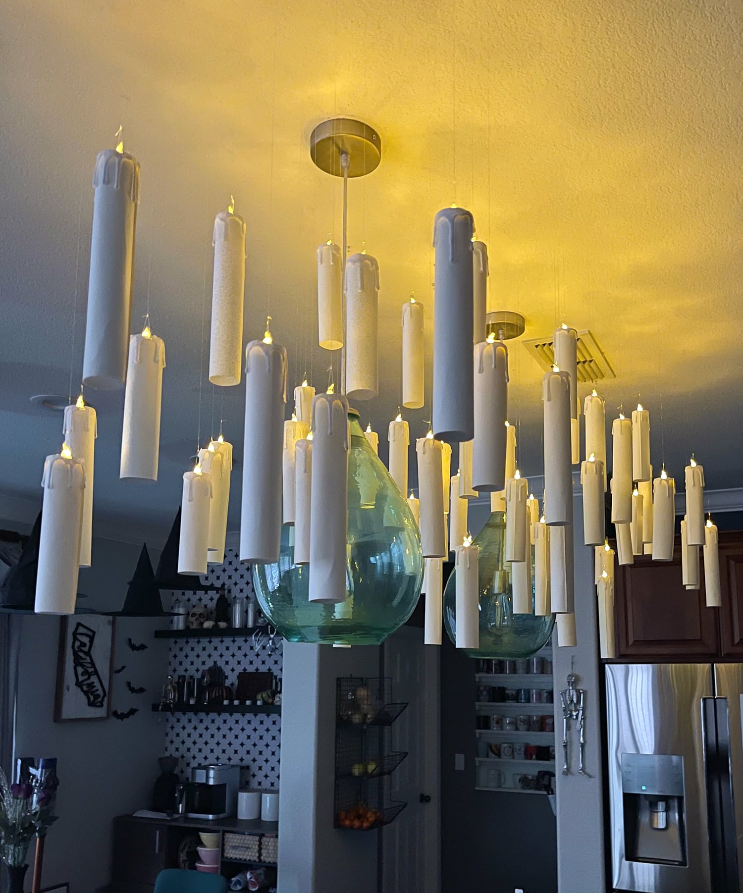Lots of Harry Potter floating candles hanging from the ceiling before a party