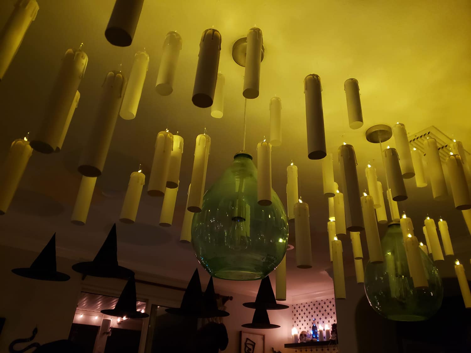 Looking up at a bunch of hanging Harry Potter floating candles on the ceiling