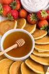 Close up of mini pancakes and dipping sauce placed on breakfast party tray