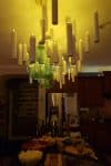 Lit Harry Potter floating candles hanging above the food buffet counter at a Halloween party
