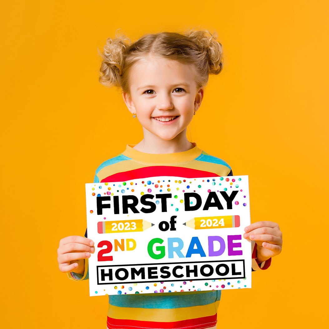 girl holding first day of 2nd grade homeschool sign