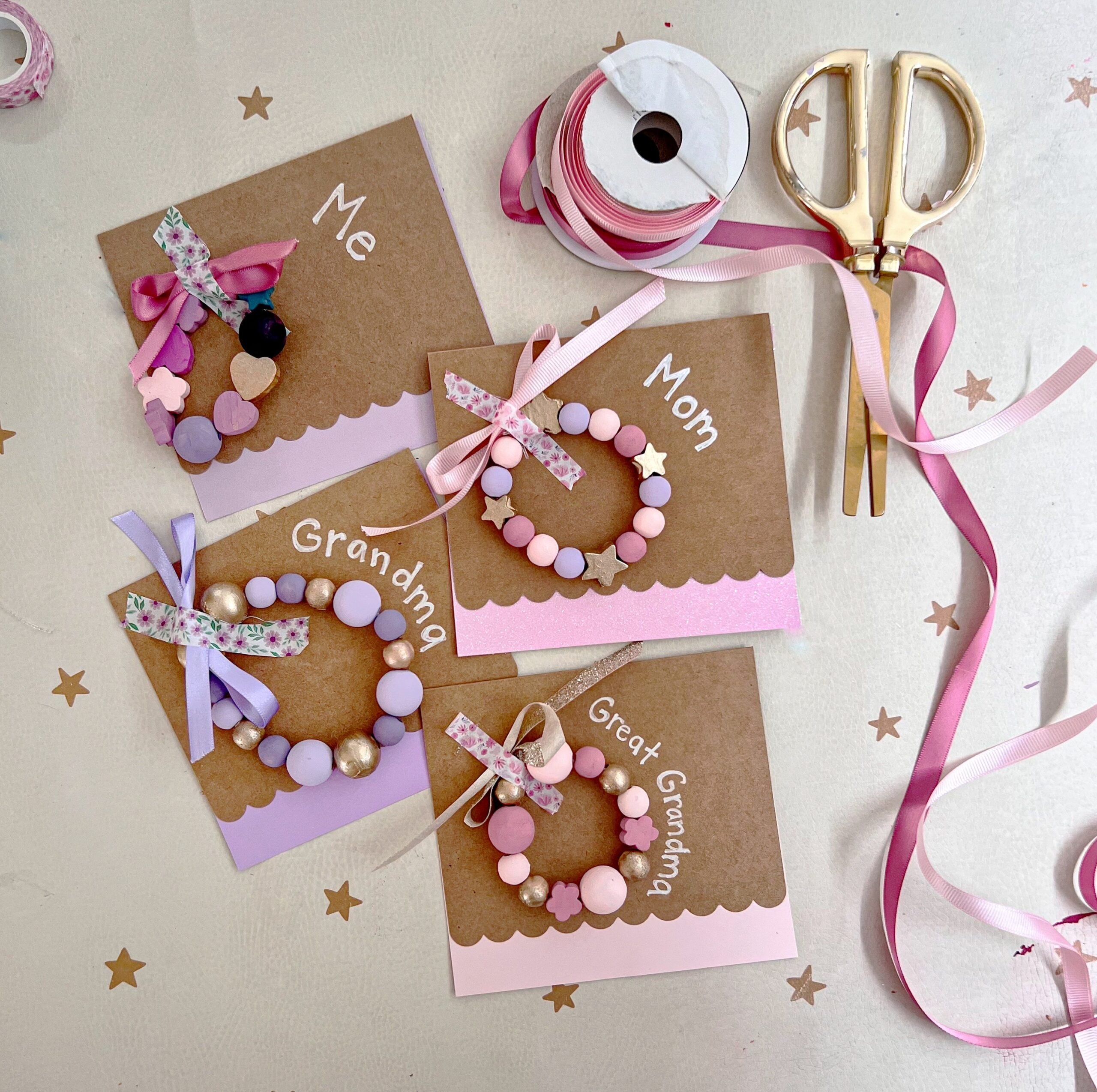 Colorful beaded bracelets on cards with the names "Mom," "Grandma," etc. surrounded by ribbon and confetti