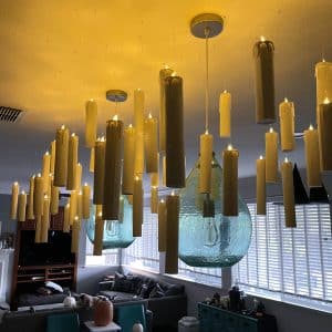 Many Harry Potter inspired floating candles hanging from the ceiling with flameless candles