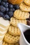 Mini waffles and fresh fruit pictured on delicious breakfast food tray