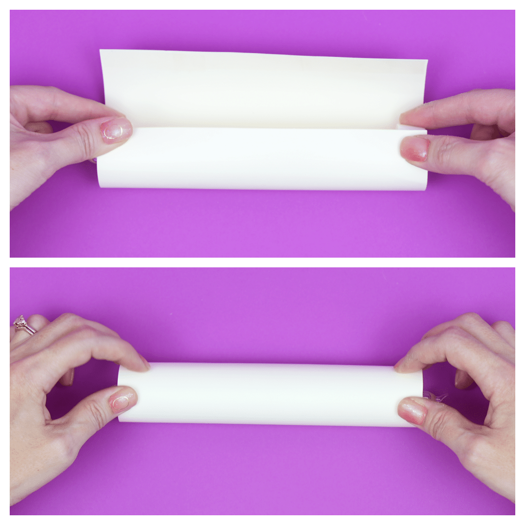Hands rolling a sheet of paper into a tube