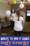 two girls are playing with balloons in the living room for minute to win it games defy gravity