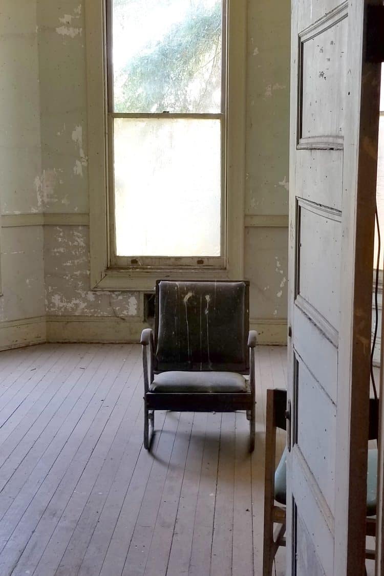 old chair in abandoned room with lots of wear