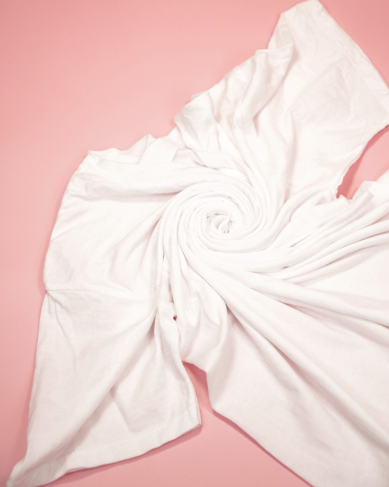 close up of spiral tie-dye folding on white shirt