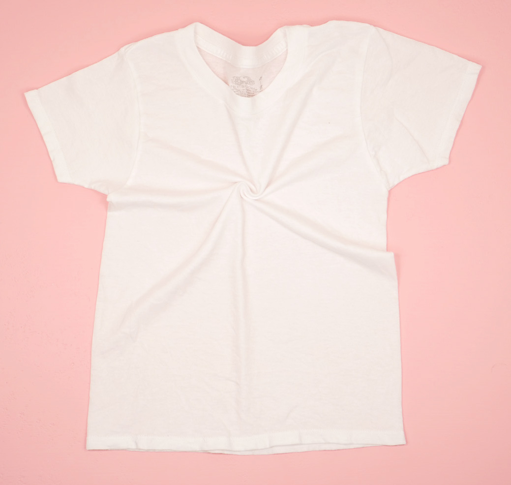 White shirt on pink background with the beginning of a spiral twist in the middle of the chest