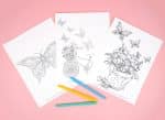 Three butterfly coloring pages with colorful markers on a pink background