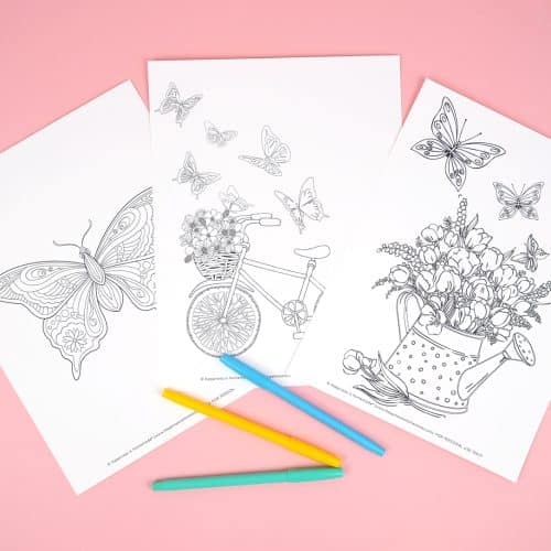 Three butterfly coloring pages with colorful markers on a pink background