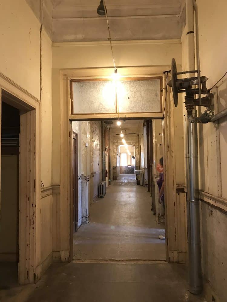Long hallway showing distinct signs of age and disrepair